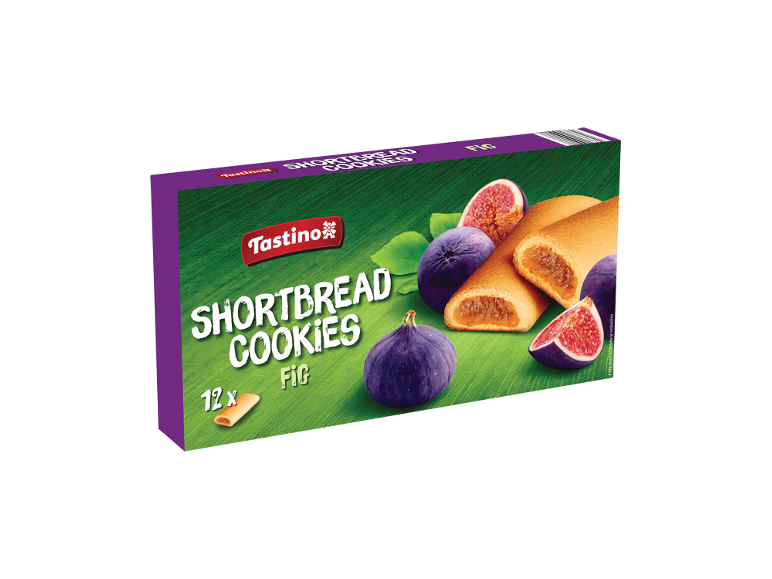 Kutija keksa sa smokvama, celim i isečenim smokvama na zelenoj pozadini.