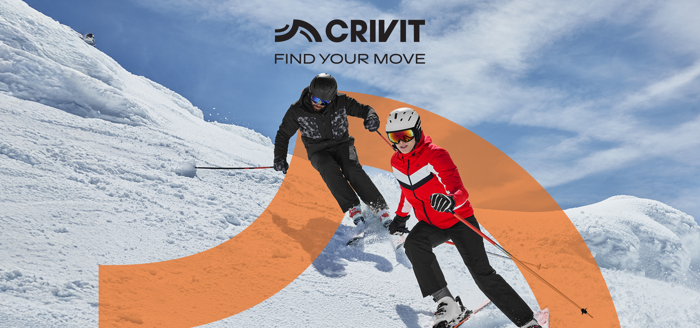 Dvoje skijaša u Crivit opremi spuštaju se niz snežnu planinu pod plavim nebom.