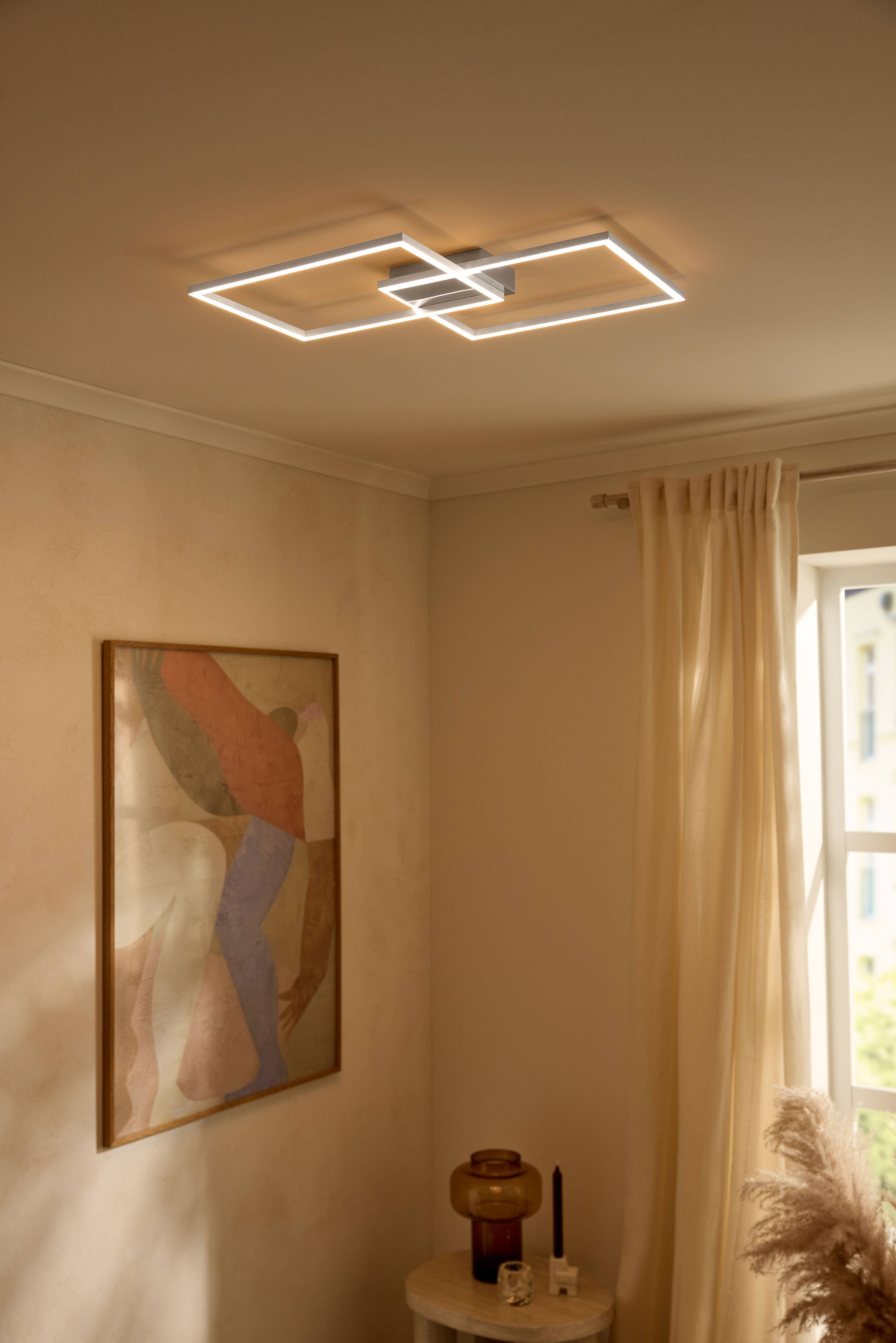 Moderna LED plafonska lampa u obliku pravougaonika, osvetljava bež sobu.