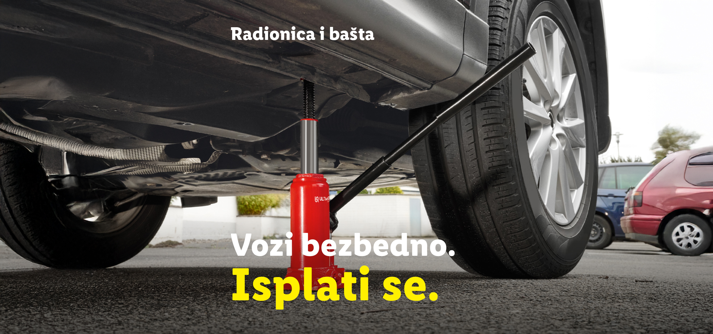 Alati za radionicu i baštu: punjenje akumulatora i dizalica za auto. Tekst: „Vozi bezbedno. Isplati se.“