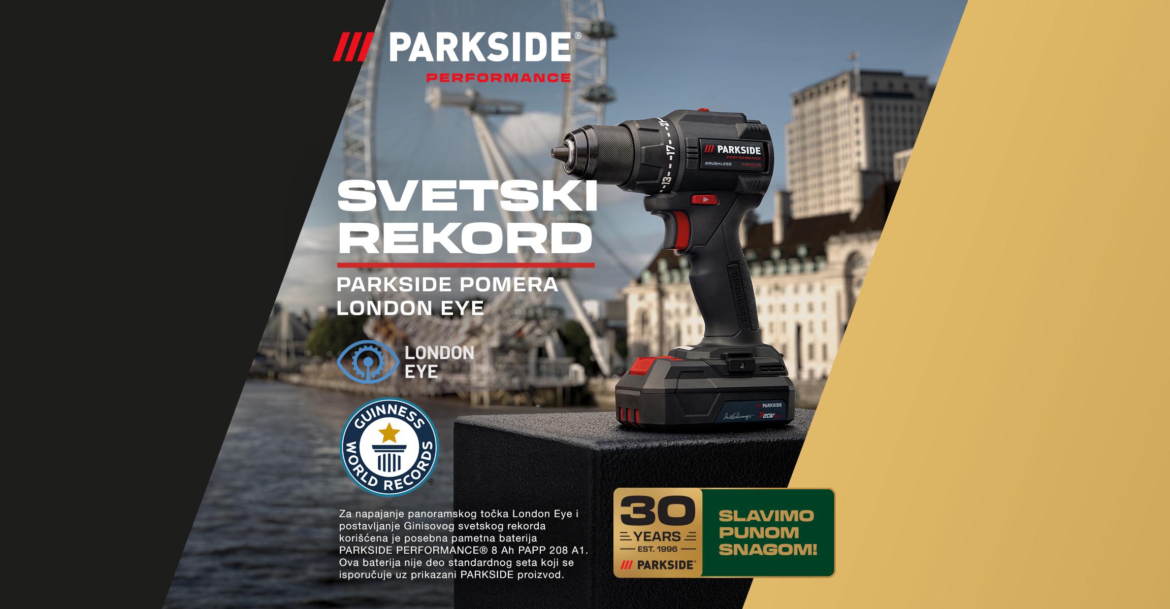 Akumulatorska bušilica-odvrtač ispred Londonskog oka, sa natpisom „SVETSKI REKORD“ i logom Ginisove knjige rekorda.