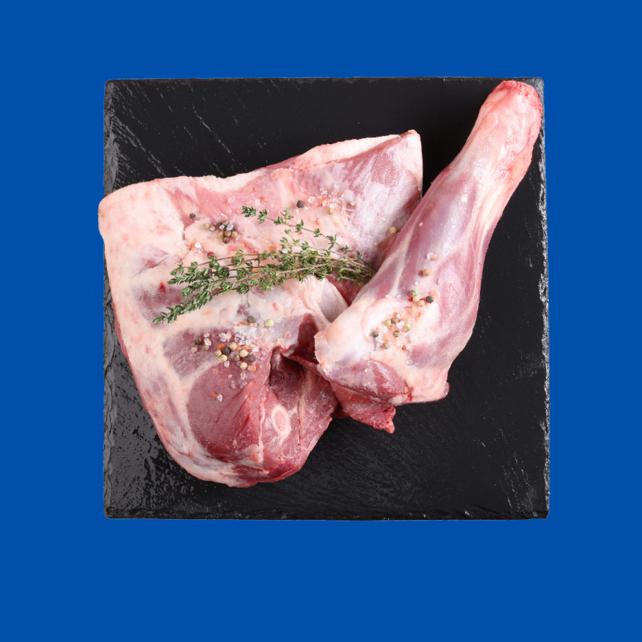 Sveža jagnjetina sa začinima i grančicom timijana na crnoj ploči.