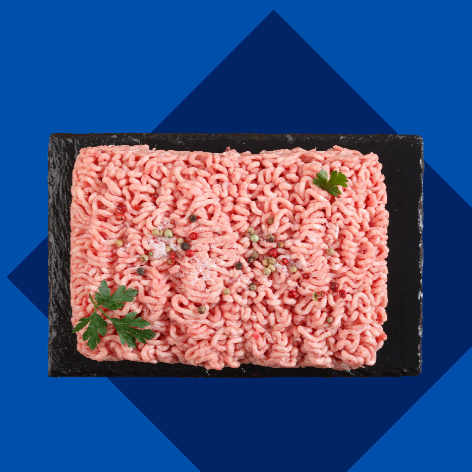 Sveže mleveno meso sa začinima i peršunom na crnoj ploči.