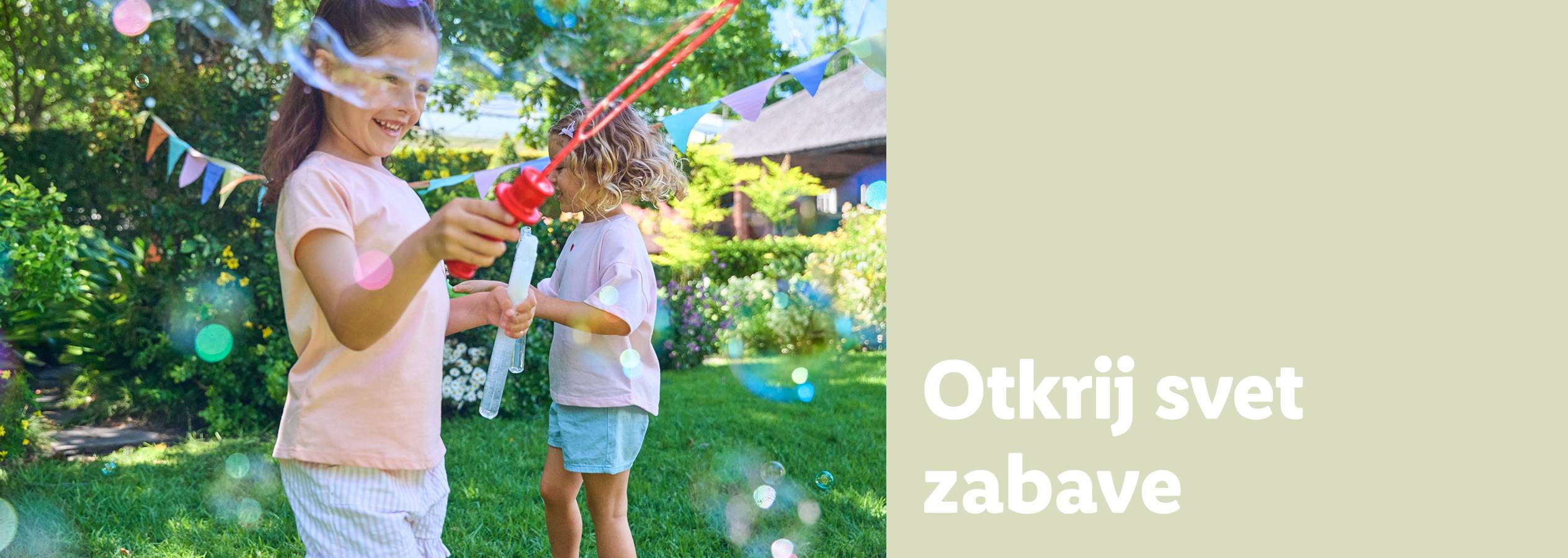 Dve devojčice se igraju sa štapićima za sapunice na otvorenom.