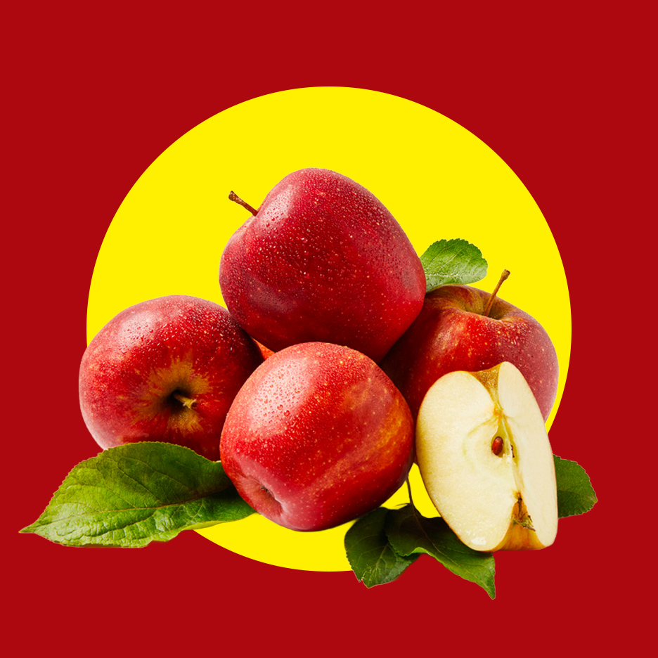 Crvene jabuke sa listovima i jednom prepolovljenom jabukom na crveno-žutoj pozadini.