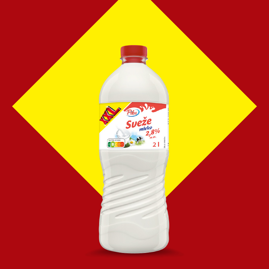 Boca svežeg mleka sa 2,8% mlečne masti na crveno-žutoj pozadini.